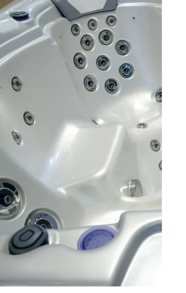 Photo of the interior of a hot tub without any water in it.
