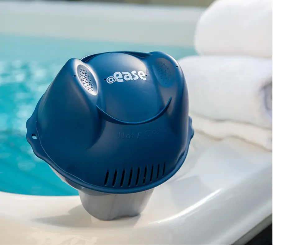 A FROG @ease for Swim Spas Sanitizing System sits on the edge of the swim spa.