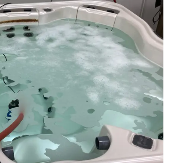 A closeup shot of a swim spa with dirty water.