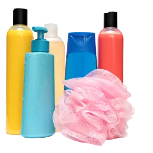 A handful of personal care bottles sit alongside a pink loofah. the image has a transparent background.